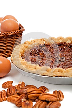 Pecan pie with ingredients on a white background