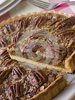 Pecan Pie With A Slice Being Cut