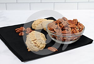 Pecan sandies cookies and a bowl of pecans
