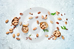 Pecans in shell on a stone background. Assortment of nuts.