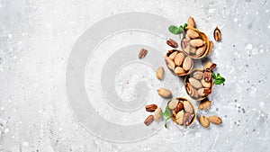 Pecans in shell on a stone background. Assortment of nuts.