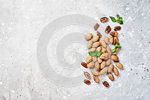 Pecans in shell on a stone background. Assortment of nuts.
