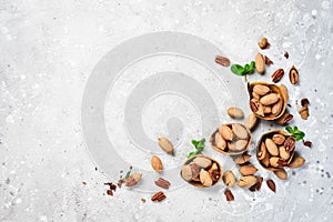 Pecans in shell on a stone background. Assortment of nuts.