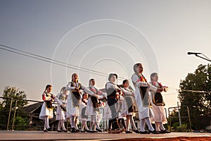 PECINCI, SERBIA - JULY 15, 2023: group of children, boys and girls dancing a Serbian kolo in Pecicni, serbia. Srpsko kolo is a