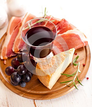 Pecorino Toscano and dry cured ham with red wine photo