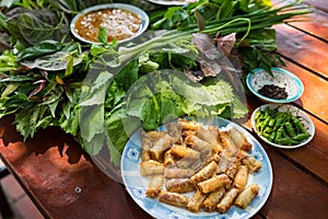 Peculiar herbs salad in Kon Tum, Vietnam. Using the leaves to make a cone-shaped container to put the food in, and use some bacon,