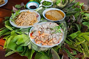 Peculiar herbs salad in Kon Tum, Vietnam. Using the leaves to make a cone-shaped container to put the food in, and use some bacon,