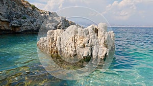 Peculiar rock in the pure sea is seen from the Bataria beach, Kassiopi, Corfu, Greece