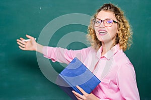 Pedagogue hold book and explaining information. Education concept. Teacher explain hard topic. Woman school teacher in