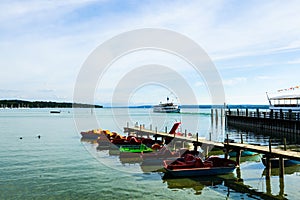 Pedal boats on the Ammersee, in the background a steamer, Bavaria, Germany photo