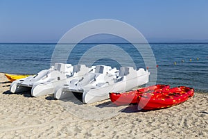 Pedal boats and kayaks for rent on sandy beach