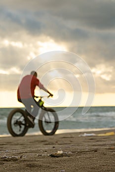 pedaling on the beach against the sun