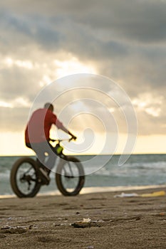 pedaling on the beach against the sun photo