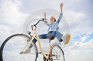 Pedaling towards happiness. Woman feels happy while enjoy cycling. Girl rides bicycle sky background. How cycling