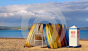 Pedallos lie unused as the sun sets over Weymouth beach