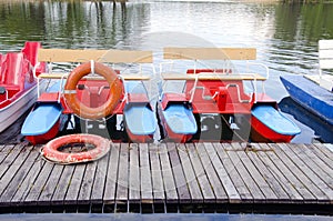 Pedalo on lake and life buoy