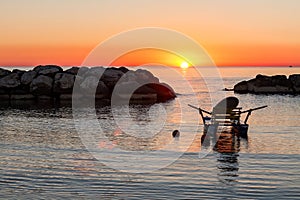 Pedalo moored in the sea during the sunrise