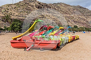 Pedalo with playground slide on the beach