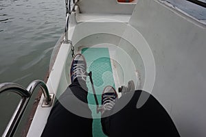 Pedals propel the cruise ship, blue canvas shoes photo