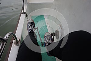 Pedals propel the cruise ship, blue canvas shoes photo
