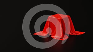 Pedestal covered with luxurious red cloth on black background in studio