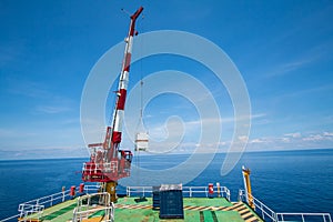 Pedestal crane, crane operator during operate crane with blue sky