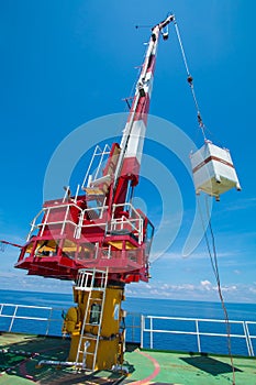 Pedestal crane, crane operator during operate crane with blue sky