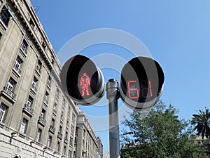 Pedestrial Crosswalk Light in Chile with Building in the Background