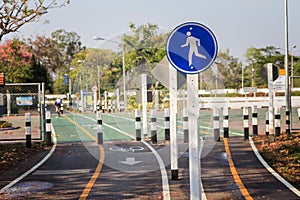 Pedestrian and bicycle riders sharing the street lanes with road marking.