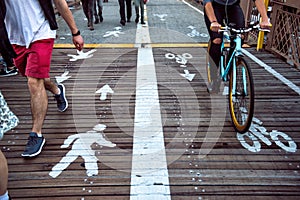 Pedestrian and bicycle riders sharing the street lanes with road marking in the city.