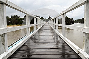 Pedestrian bridge crossing on an overcast and drizzly day