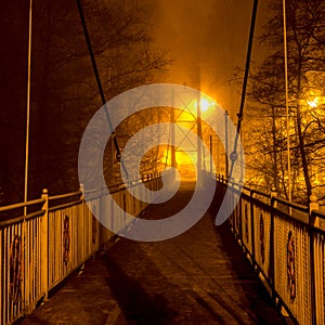 Pedestrian bridge in dense fog at night