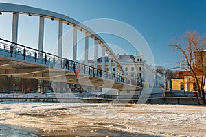 Pedestrian bridge Kaarsild and the view on the embankment of EmajÃµgi river