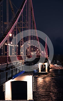 Pedestrian bridge at night with LED lights. Kyiv