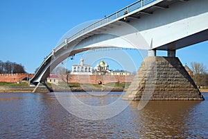 Pedestrian bridge over the Volkhov river against the background of the Kremlin of Veliky Novgorod. Russia