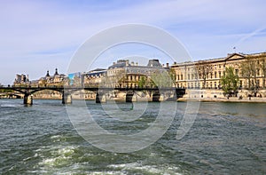 Pedestrian bridge Pont des Arts over Seine river and historic buildings of Paris France