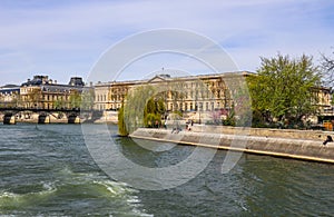 Pedestrian bridge Pont des Arts over Seine river and historic buildings of Paris France