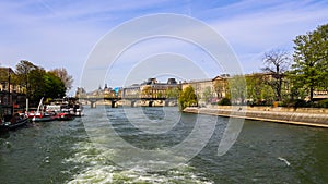 Pedestrian bridge Pont des Arts over Seine river and historic buildings of Paris France