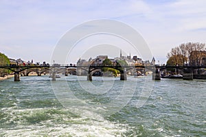 Pedestrian bridge Pont des Arts over Seine river and historic buildings of Paris France