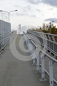 Pedestrian bridge with white railing