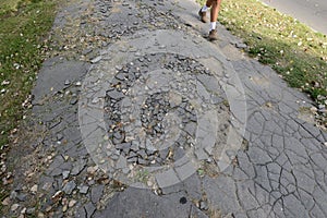 Pedestrian on cracked asphalt