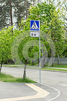 A pedestrian crossing and blind road sign