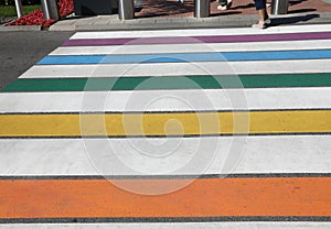 pedestrian crossing with the multicolored stripes of the road where pedestrians walk