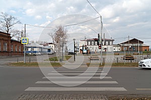 A pedestrian crossing over the roadway leads to the central square with historic buildings. Yeniseisk. Krasnoyarsk region. Russia