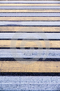 Pedestrian crossing. Road markings on asphalt. Striped blue and yellow background and texture