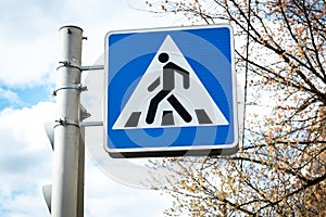 Pedestrian crossing sign in city