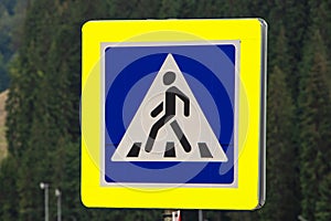 Pedestrian crossing sign on forest background