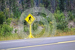 A pedestrian crossing sign on a highway
