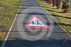 Pedestrian crossing sign, pedestrian zone, beware of pedestrians on the road. horizontal signage on asphalt red triangle with a sy