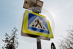 The pedestrian crossing sign powered by solar panels installed above